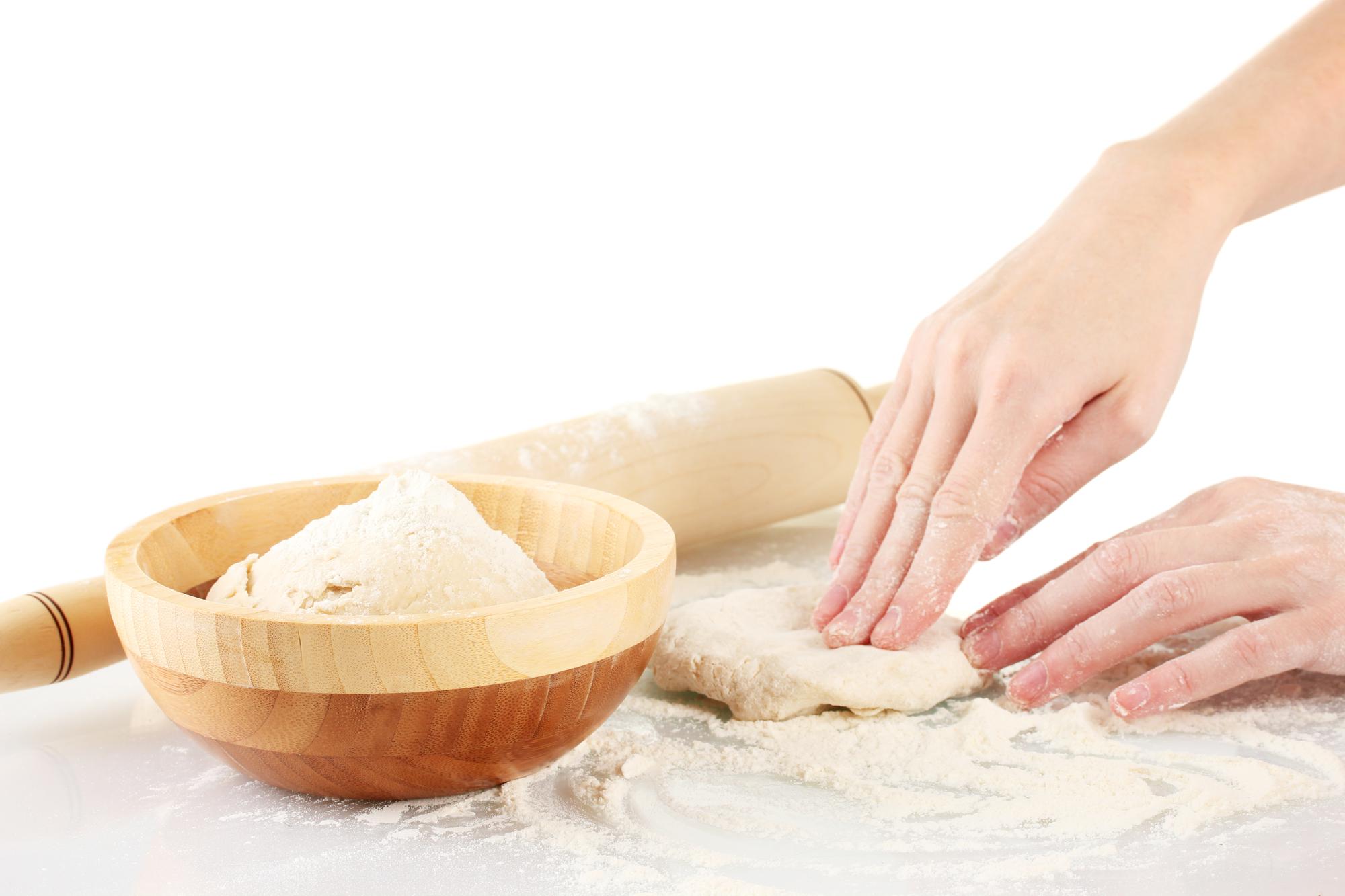 Participant kneading dough at workshop table